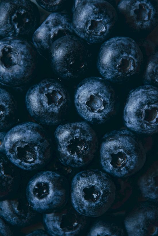 The image shows a close-up view of fresh blueberries arranged together.