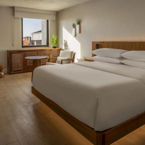 Daylight-filled guest room at The Amaya with clean lines, warm materials, and a calm atmosphere