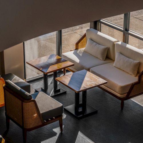 Evening lighting in The Amaya lobby, highlighting warm materials, architectural rhythm, and a relaxed atmosphere